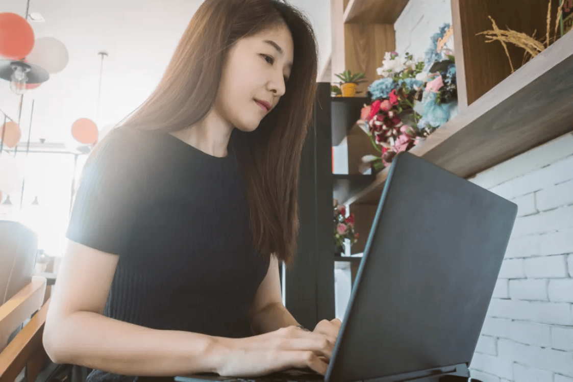 Woman writing on laptop